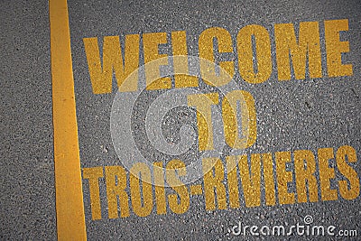 asphalt road with text welcome to Trois-Rivieres near yellow line Stock Photo