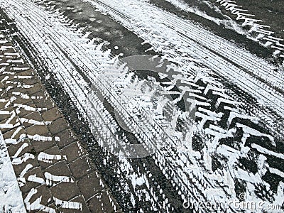 Asphalt with snowy tires imprints. winter background Stock Photo