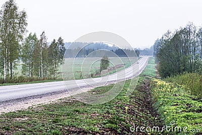 Asphalted rural road with some cars Stock Photo
