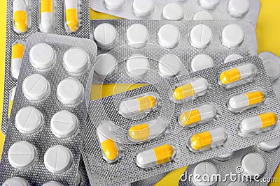 Aspirin in round white tablets on a radiant background. Chemical pills in blisters. Therapeutic drugs, antibiotics, painkillers. Stock Photo