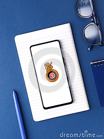 Assam, india - August 27, 2020 : Royal challengers bangalore logo on phone screen stock image. Editorial Stock Photo