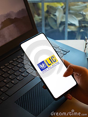 Assam, india - December 20, 2020 : LIC logo on phone screen stock image. Editorial Stock Photo