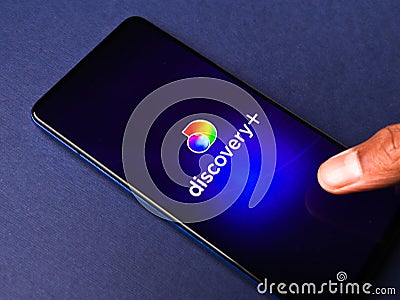Assam, india - March 10, 2021 : Discovery plus logo on phone screen stock image. Editorial Stock Photo