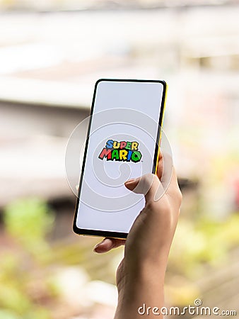 Assam, india - September 24, 2020 : Super Mario logo on phone screen stock image. Editorial Stock Photo