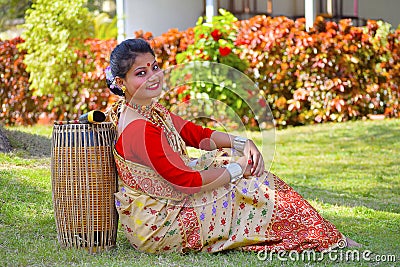 Assamese girl In traditional attire posing with A Dhol, Pune, Maharashtra. Stock Photo