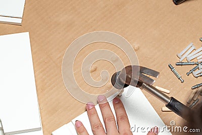 Assembling of furniture, closeup of hammer in hand Stock Photo