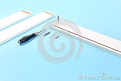 Assembly of flat packed furniture on blue Stock Photo