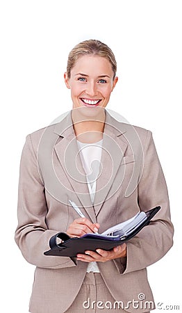 Assertive businesswoman making notes on her agenda Stock Photo