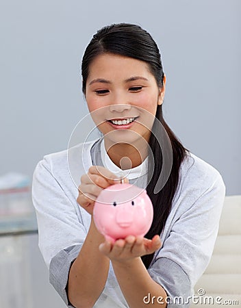 Assertive businesswoman saving money Stock Photo