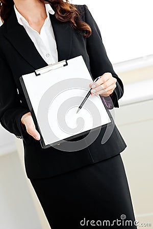 Assertive businesswoman taking notes on clipboard Stock Photo