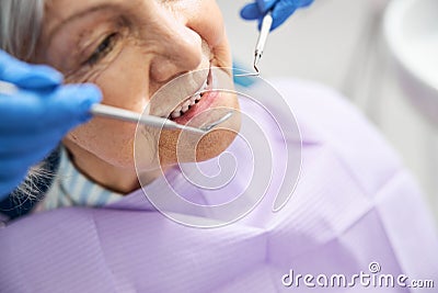 Assessment of old person teeth with dental devices Stock Photo