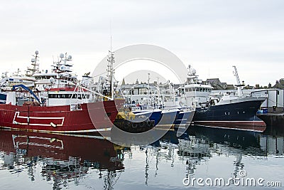 Assessment of big ships and small boats in Fraserburgh Harbour,Aberdeenshire, Scotland, UK. Editorial Stock Photo