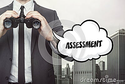 Assessment text on blackboard with businessman Stock Photo