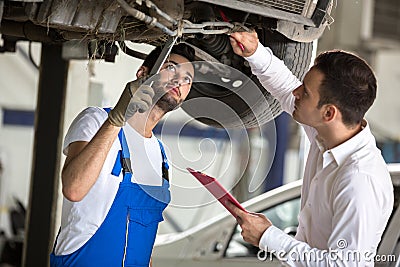 Assessor and repair man examine car Stock Photo