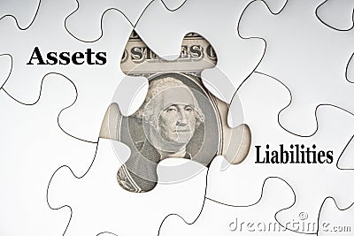 ASSETS LIABILITIES text with Dollar banknotes on white jigsaw puzzle Stock Photo