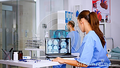 Assistant expertise doctor in medical uniform examining digital x-ray Stock Photo