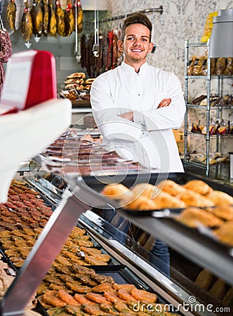 Assistant in grocery shop greeting customers Stock Photo