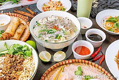 Assorted asian dinner, vietnamese food. Pho ga, pho bo, noodles, spring rolls top view Stock Photo