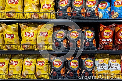 Los Angeles, CA USA March 1st 2022 Assorted bags of lay`s brand potato chips for sale at a supermarket shelf Editorial Stock Photo