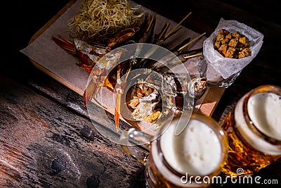 Assorted beer snacks with beer mugs Stock Photo