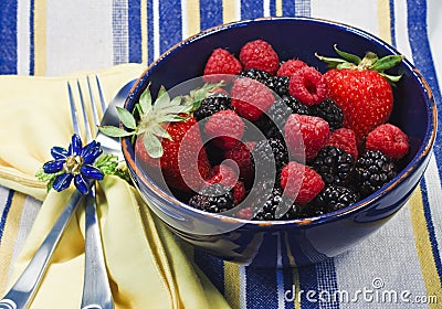 Assorted berries in a blue bowl Stock Photo