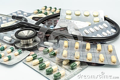 Assorted of blister pack pills with black stethoscope on Stock Photo