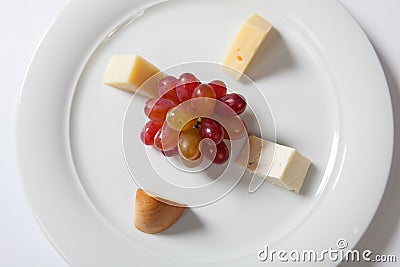 Assorted cheeses and grape on a white plate Stock Photo