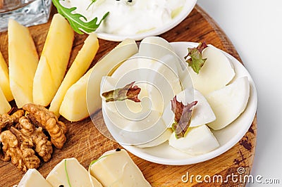 Assorted cheeses and wallnuts Stock Photo