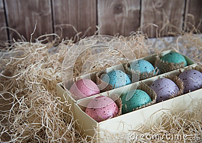 Assorted colorful painted easter eggs in a gift box, , with woodchips Stock Photo