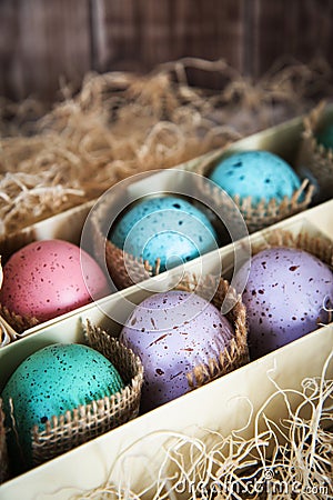 Assorted colorful painted easter eggs in a gift box, , with woodchips Stock Photo