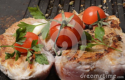 Assorted delicious grilled meat with vegetable over the coals on a barbecue in closeup Stock Photo