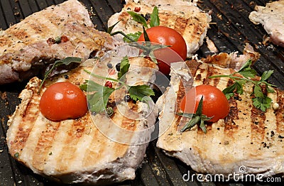 Assorted delicious grilled meat with vegetable over the coals on a barbecue in closeup Stock Photo