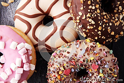 Assorted donuts with chocolate frosted, pink glazed and sprinkle Stock Photo