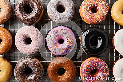 Assorted donuts displayed on kitchen table, tempting pastry delights Stock Photo