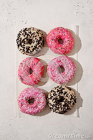 Assorted donuts pink and chocolate on white background Stock Photo