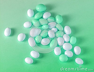 Green fullcolor and white candy dragees. Stock Photo