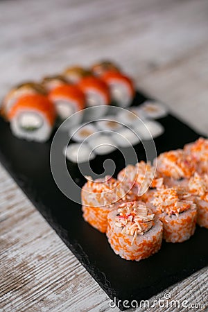 Assorted japanese sushi rolls on black background Stock Photo