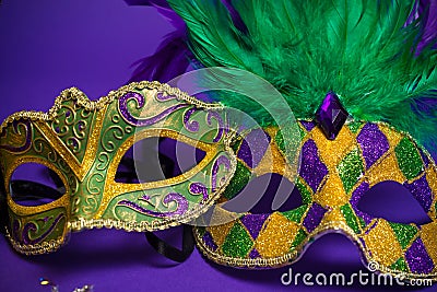 Assorted Mardi Gras or Carnivale masks on purple Stock Photo