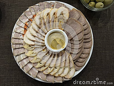 Assorted meat cuts. snack on a white plate Stock Photo