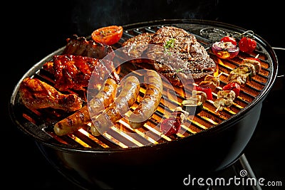 Assorted meat grilling over the fire at a BBQ Stock Photo