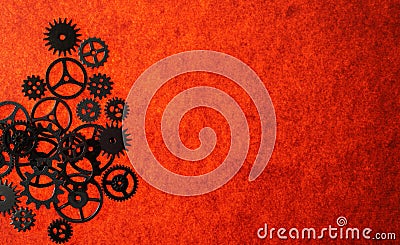 Assorted mechanical gears on orange textured background with copy space Stock Photo