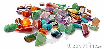 Assorted natural bright coloured semi precious gemstones and gems on white background Stock Photo