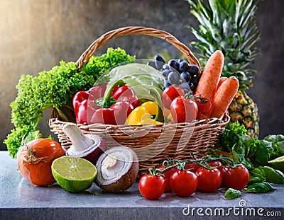 Assorted organic vegetables and fruits in wicker baske Stock Photo