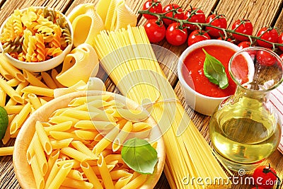 Assorted pasta, tomato passata and olive oil Stock Photo