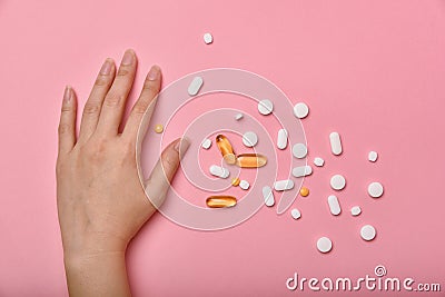 Assorted pharmaceutical medicine, Hand taking too much medication pills Stock Photo