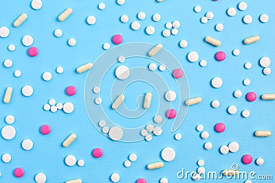 Assorted pharmaceutical medicine pills, tablets and capsules. medical pattern on a blue background. Stock Photo