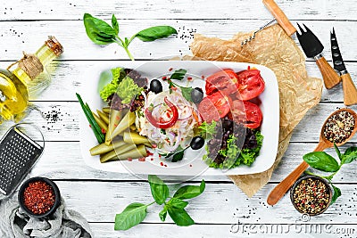 Assorted pickled vegetables on a plate. On the old wooden background. Free space for text. Stock Photo