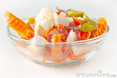 Assorted pickles vegetables carrot, chili, cauliflower in glass bowl. Top view. . Stock Photo