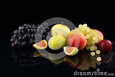 Assorted ripe fruits, grapes, apples, cherry plum and figs on black glass Stock Photo