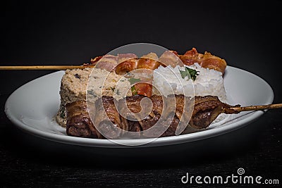 Assorted skewers on black background Stock Photo